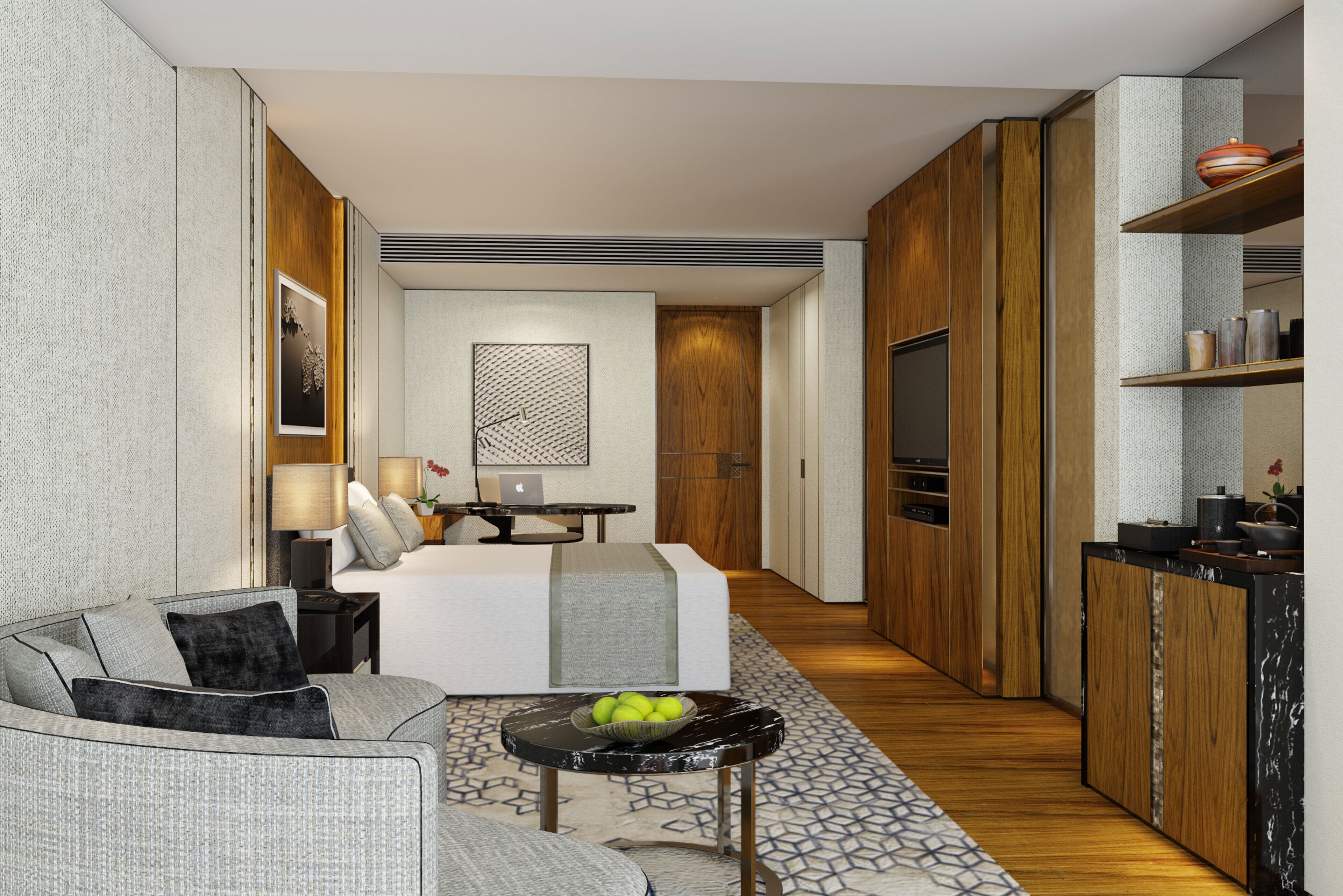 A modern hotel room with a bed, seating area, and kitchenette.