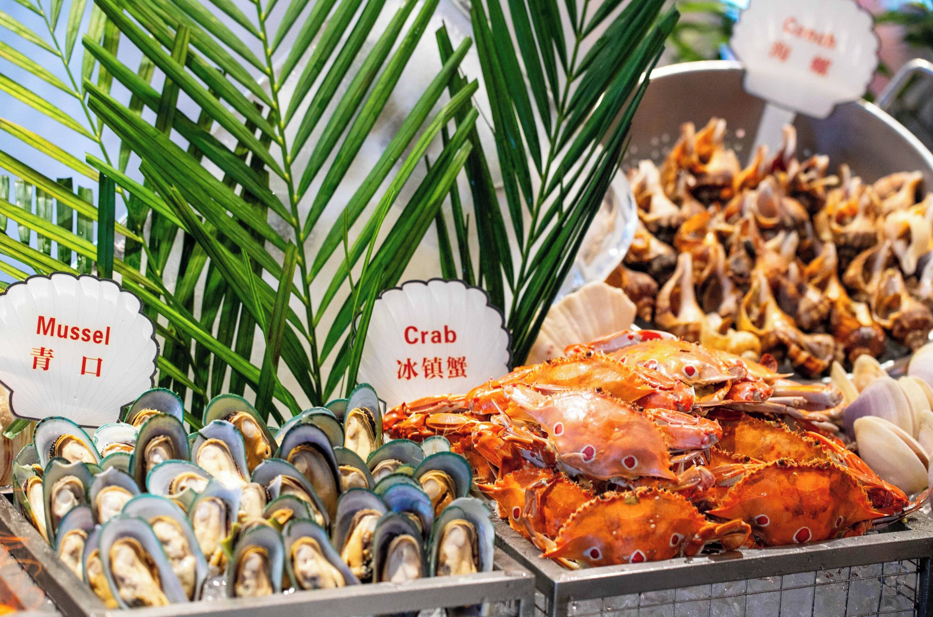 A seafood display with mussels and crabs.