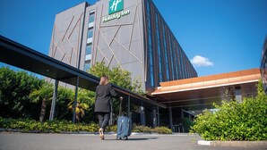A Holiday Inn hotel with a modern architectural design, featuring a prominent logo on the building facade. - Holiday Inn Sydney St Marys by IHG (North St Marys)