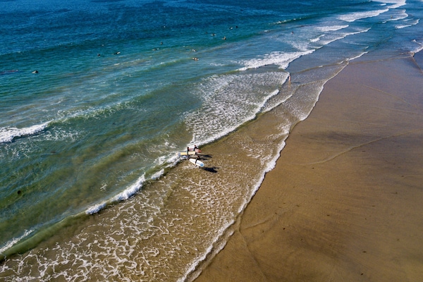 Beach nearby, white sand, beach umbrellas, beach towels
