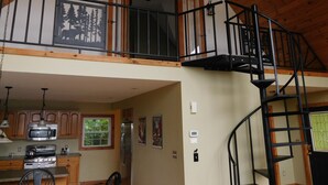 A spacious loft-style kitchen with wooden beams, a mezzanine with a balcony, and a modern stainless steel refrigerator. - Private 4-bedroom chalet with breathtaking views! (Great Valley)