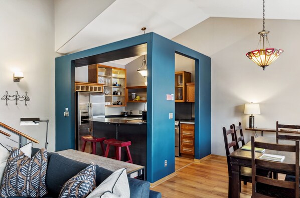 A compact living space with a kitchenette, a dining area, and a seating area with a sofa and chairs. - Outpost: Clark's Knoll 353 - Walk to Town Square (Jackson)