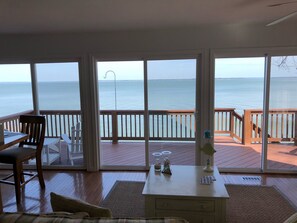 A room with a view of the sea, a wooden deck, and a table with decorative items. - It’s All about the VIEW….and you ! October rates have been reduced ! (Montross)