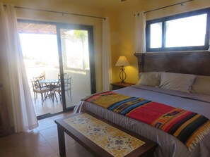 A hotel room with a bed, a table, and a chair.