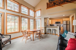 Relax in this inviting space with a high ceiling and expansive views of the outdoors through large windows.