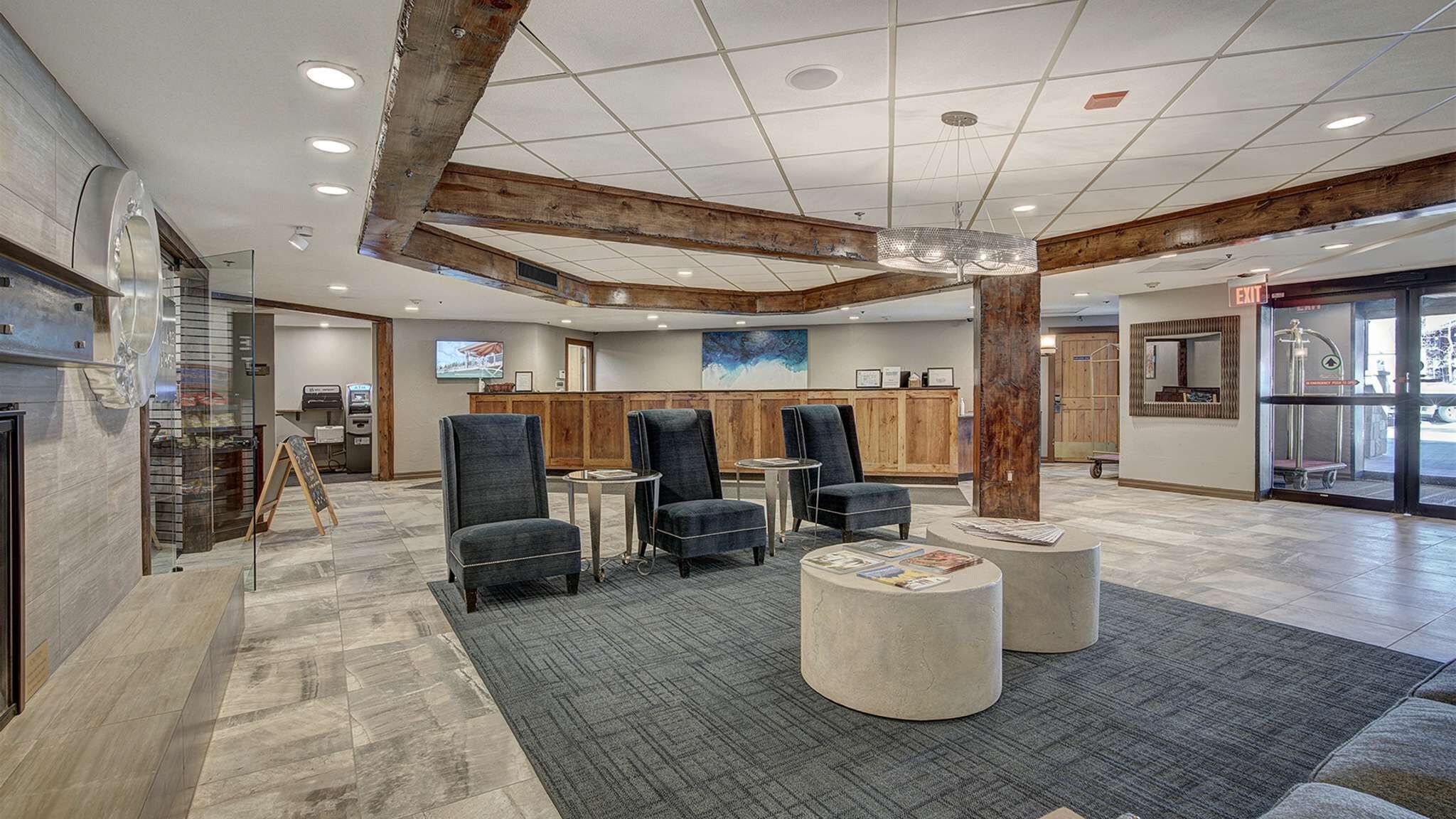 A lobby with a reception desk, seating area, and a large pillar.