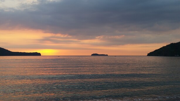 A coastal sunset with calm waters and distant landforms. - The Inn at Calayo (Nasugbu)