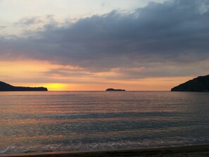 A coastal sunset with calm waters and distant landforms. - The Inn at Calayo (Nasugbu)