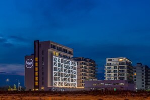 A hotel with a prominent 'NYOTA' sign, multiple floors, and a modern architectural design. - Nyota Hotel & Conference Center (Constanta)