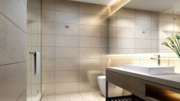 A modern bathroom with a large mirror, a white sink, and a glass shower enclosure.