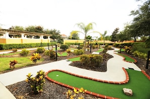 Stroll through the beautifully landscaped garden, featuring a serene pond and variety of plants.