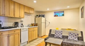 Enjoy a compact living space with a kitchenette, sofa, and coffee maker.