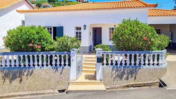 A white building with a tiled roof, a gated entrance, and a small staircase leading to the door. - Casa da Achada in Arco da Calheta (Arco da Calheta)
