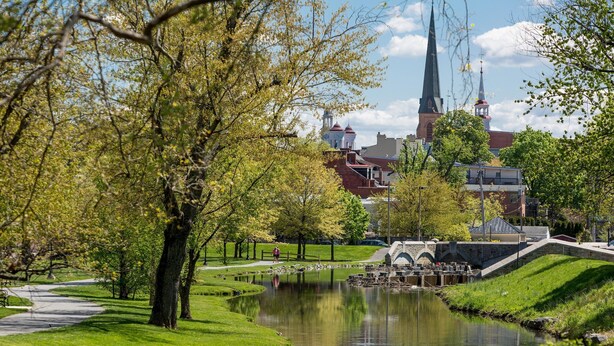 A park with a pond, a bridge, and a church in the background. - RETREAT on the CREEK - Businees Travelor or Weekend Getaway. HISTORIC DISTRICT. (Frederick)