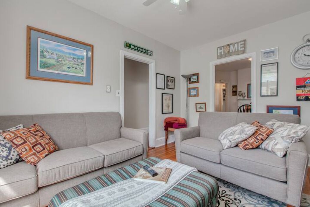 A living room with two sofas, a coffee table, and a framed picture on the wall.