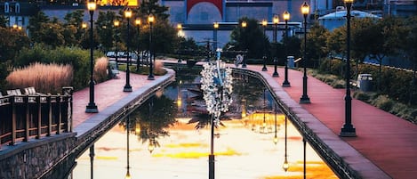 A sunset over a canal with a Ferris wheel in the background.