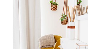 A bright, minimalist room with a yellow chair, white sofa, and a white desk. - Fantastay - Portokal Downtown Dubai (Dubai)
