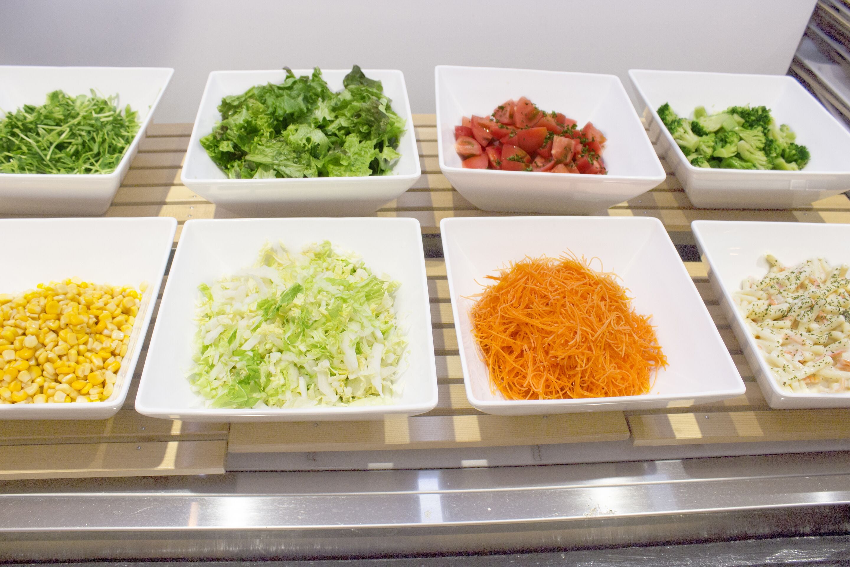 A display of various food items in white bowls.
