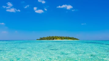 On the beach, white sand, sun-loungers, beach umbrellas