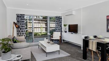 Central City Escape Apartment G06 | Living area | Flat-screen TV