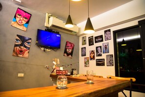 Enjoy a stylish space with a flat-screen TV, artwork, and a bar counter.