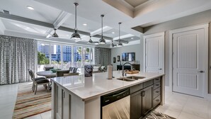 A modern kitchen with a central island, built-in dishwasher, and pendant lighting. - Luxury North Beach Resort home w/ pool/elevator & marsh/ocean view (North Myrtle Beach)