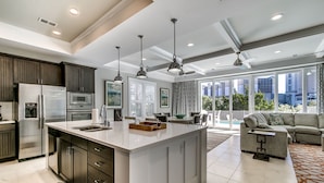 A modern kitchen with a large island, stainless steel appliances, and pendant lighting. - Luxury North Beach Resort home w/ pool/elevator & marsh/ocean view (North Myrtle Beach)