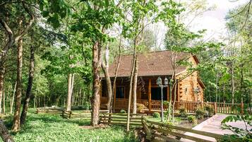 A wooden cabin surrounded by trees.