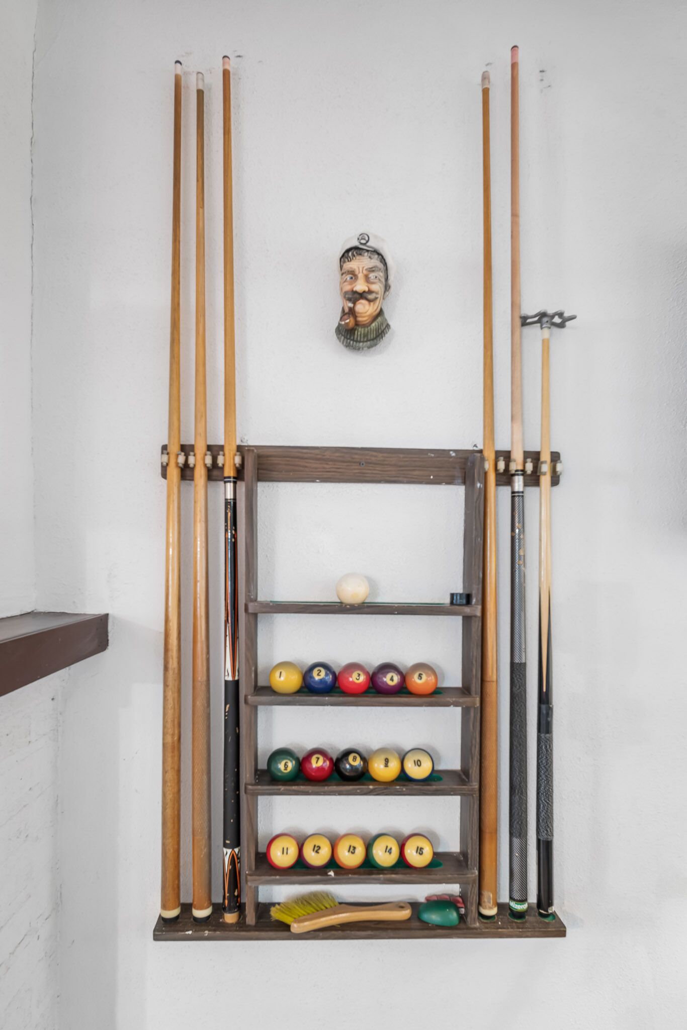 A pool table with various balls and cues.