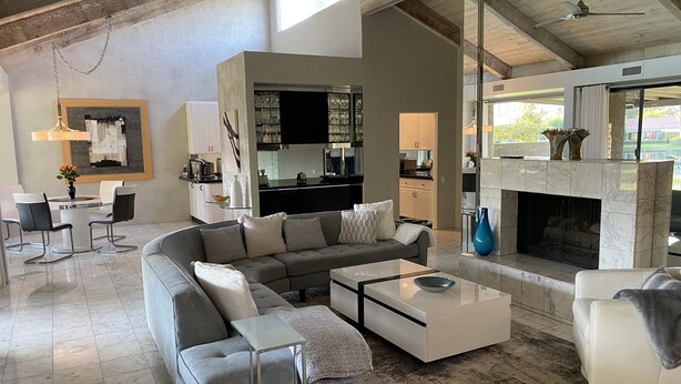 A spacious living area with a sectional sofa, a coffee table, and a fireplace.