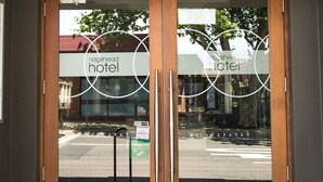 A hotel entrance with double glass doors and a wooden frame. - Nags Head Hotel (Adamstown)