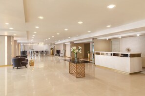 A spacious lobby with a reception desk, seating area, and a decorative vase. - Pyay Garden Residence (Yangon)