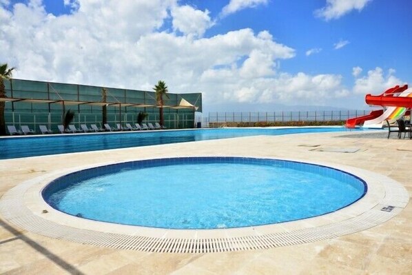 Indoor pool, outdoor pool, pool umbrellas, pool loungers