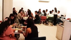 A dining area with round tables and chairs, a ceiling fan, and an air conditioning unit. - Omni Plaza (Jodhpur)