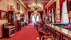 A luxurious hotel lobby with ornate chandeliers, red carpet flooring, and classic furniture. - Grand Hotel de Londres (Istanbul)