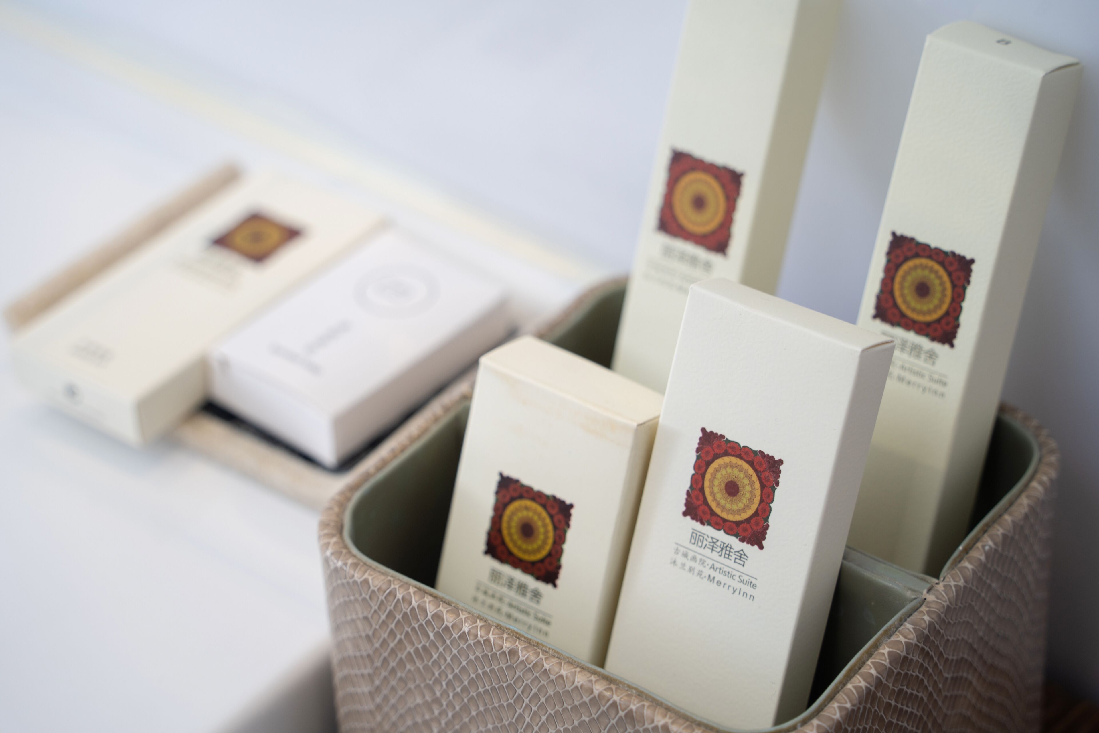 A set of neatly arranged boxes with a distinct logo, placed in a woven basket.