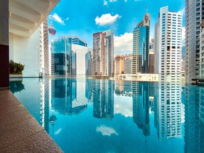 A modern building with a reflective pool in front.
