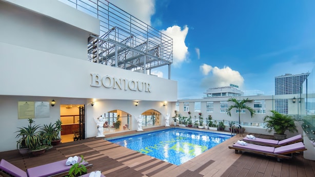 A rooftop pool area with lounge chairs and potted plants. - Bonjour Nha Trang Hotel (Nha Trang)