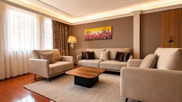 A modern living room with two sofas, a coffee table, and a lamp.