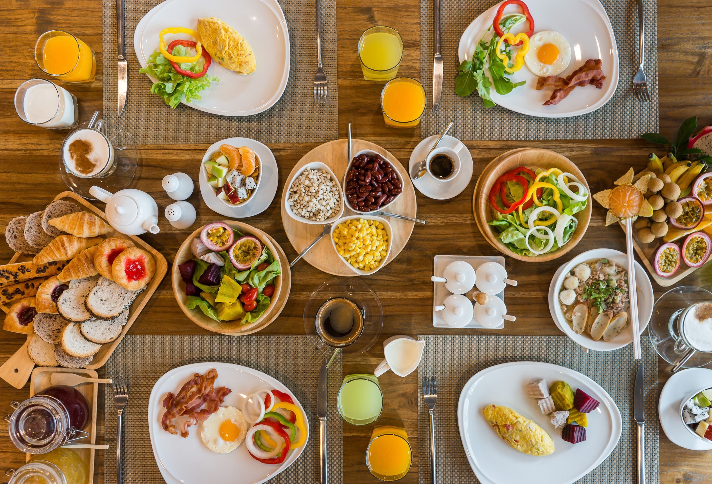 A breakfast buffet with various dishes and beverages.