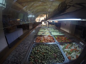 A buffet with various food options, including olives, vegetables, and meats. - Golden Sand (Lloret de Mar)