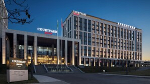 Een Courtyard Marriott hotel met een moderne gevel, grote ramen en een opvallende entree.