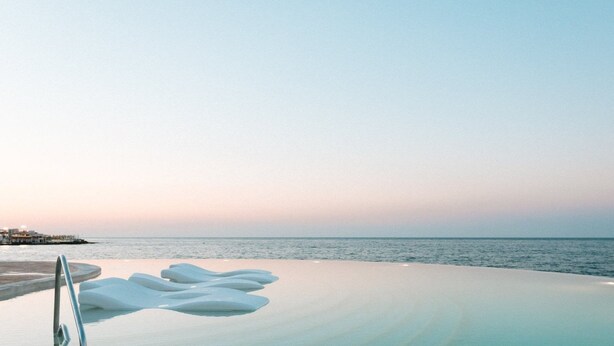 A beach with a clear sky, a sandy area, and a water body. - 1926 Le Soleil Hotel & SPA (Sliema)