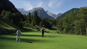 A golf course with a mountainous backdrop. - Kella-Egg (Brand)