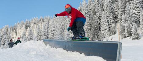 A snowboarder performing a trick on a rail.