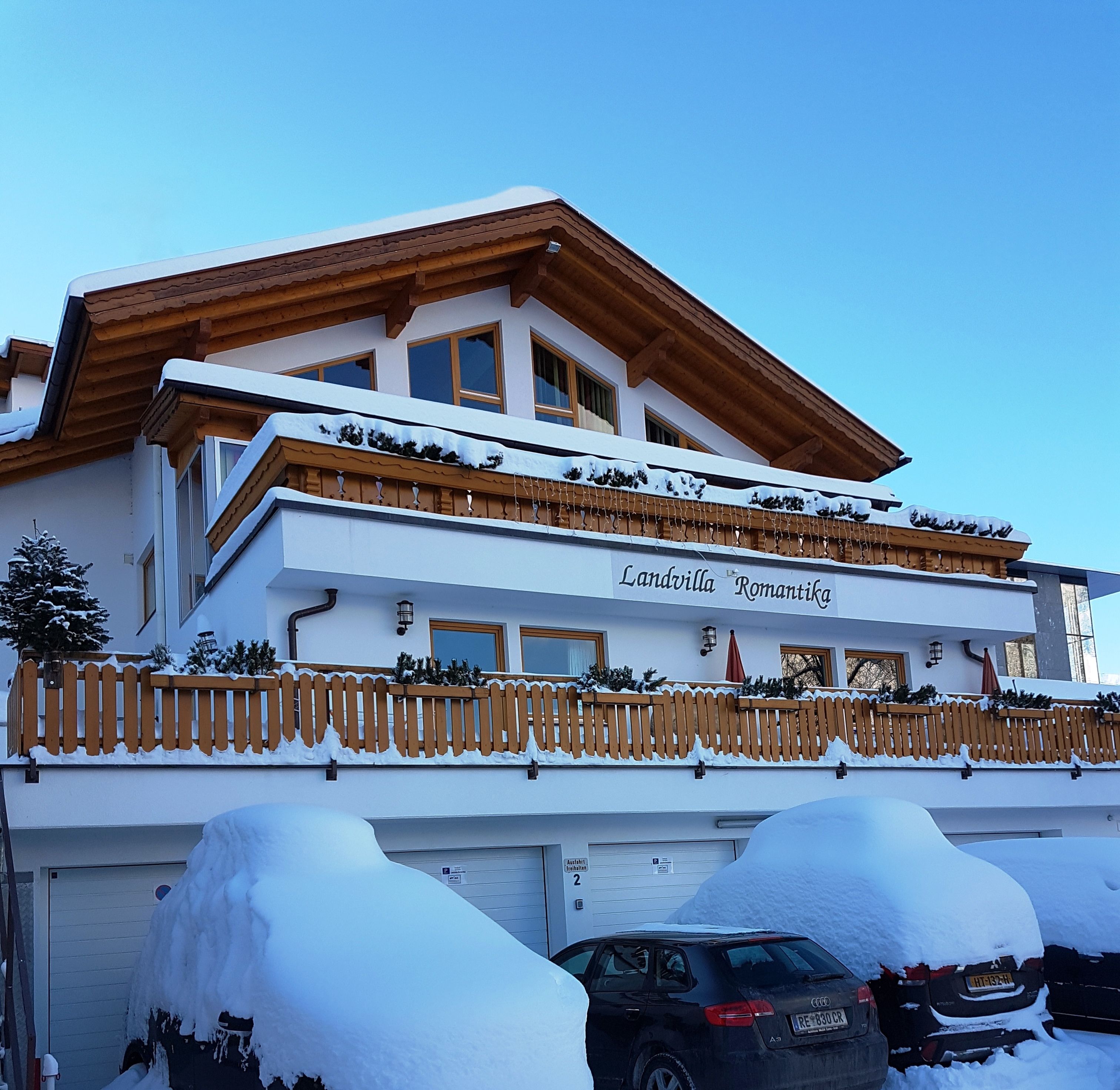 A two-story building with a sign reading "Landvilla Romantik."