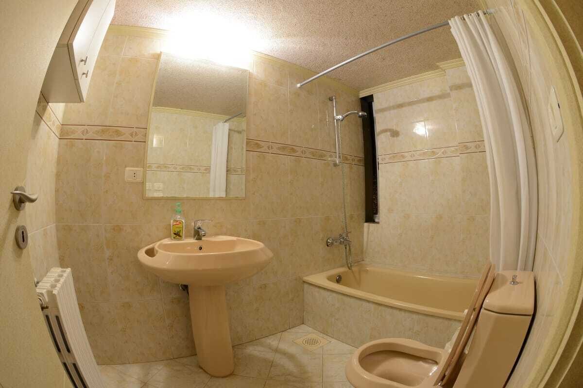 A bathroom with a sink, toilet, and bathtub.
