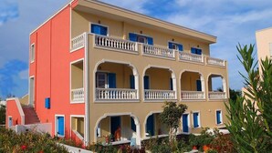 A multi-story building with balconies and arched windows. - Avra Hotel (Santorini)