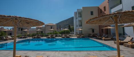 Outdoor pool, open 9:00 AM to 6:00 PM, pool umbrellas, pool loungers