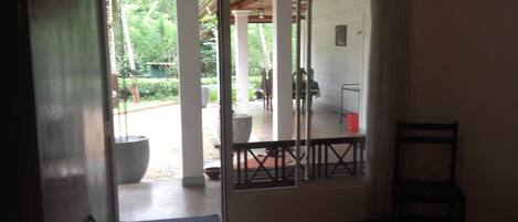 A room with a sliding glass door leading to an outdoor patio area.